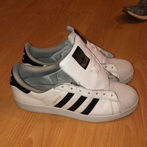 Male Adidas original superstar sneakers.